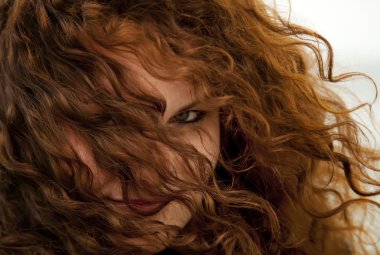 Close-up view in eye of curly red-haired girl. clipart