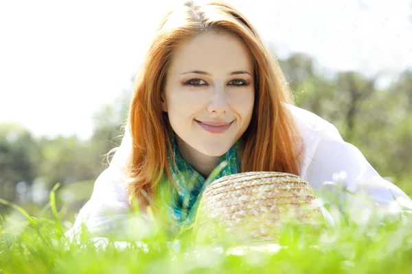 Beautiful red-haired girl with hat at the park. — Stock Photo, Image