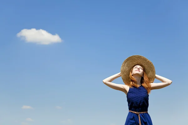 Κοκκινομάλλα κοπέλα στο φόντο του μπλε ουρανού άνοιξη. — Φωτογραφία Αρχείου