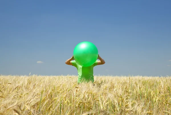 Men with green ball at wheat field. — Stock Photo, Image