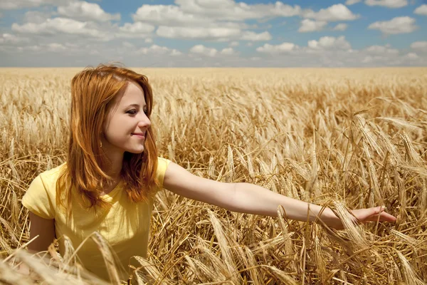 Redhead girl sleeping at wheat field at summertime. — Stock Photo, Image
