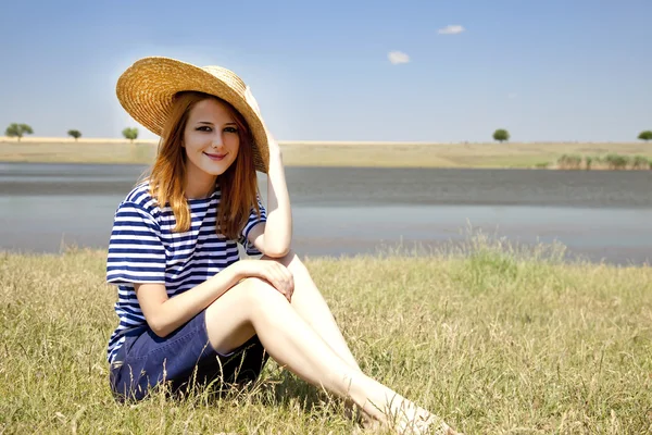 Beautiful redhead girl at countryside nead lake. — Stock Photo, Image
