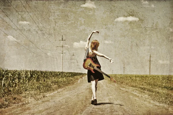Rock girl with guitar at countryside. Photo in old image style. — Stock Photo, Image