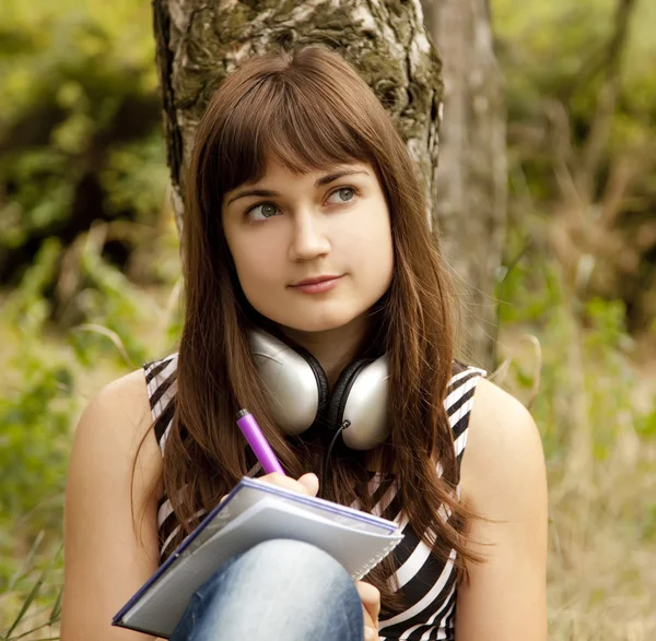 公園で宿題をやっている若い十代の少女. — ストック写真