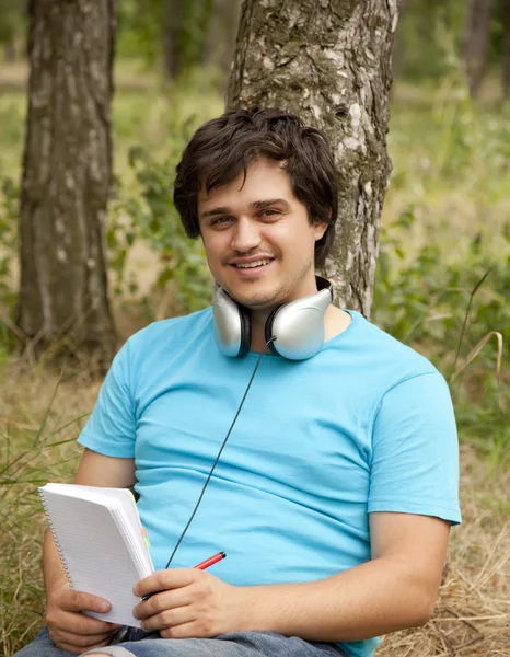 Student with notebook and headphones. — Stock Photo, Image