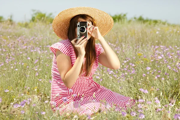 Retro style girl at countryside with camera. — Stock Photo, Image
