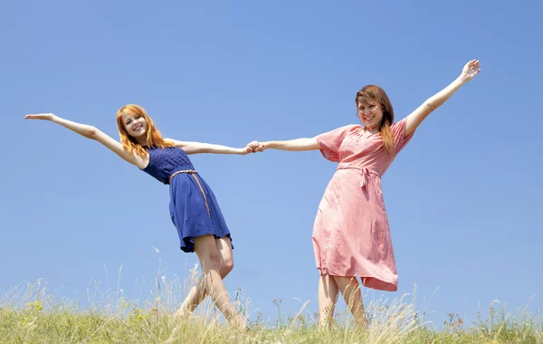 在草地上的两个快乐女孩. — 图库照片