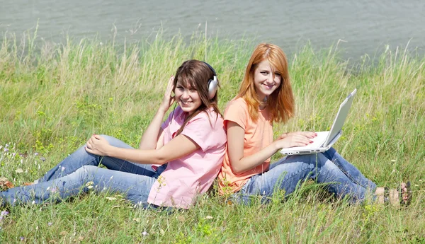 Two girlfriends at countryside with laptop and computer. — Stock Photo, Image