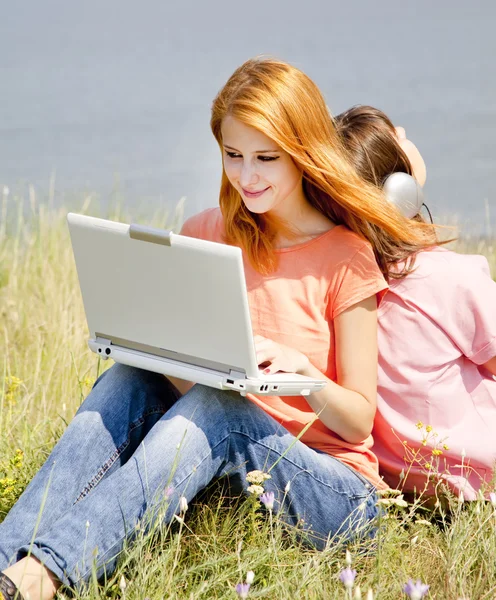 Two girlfriends at countryside with laptop and computer. — Stock Photo, Image