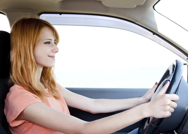 stock image Redhead girl in the car.