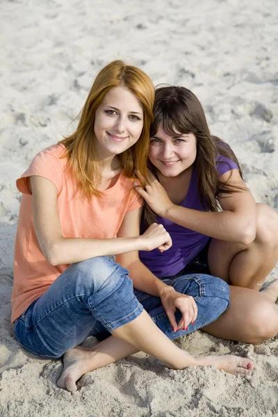 Two girlfriends at sand. — Stock Photo, Image