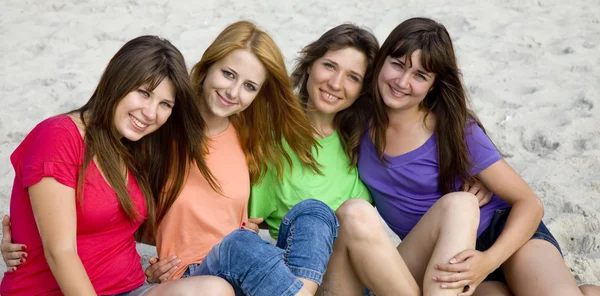 Four girlfriends at sand. — Stock Photo, Image