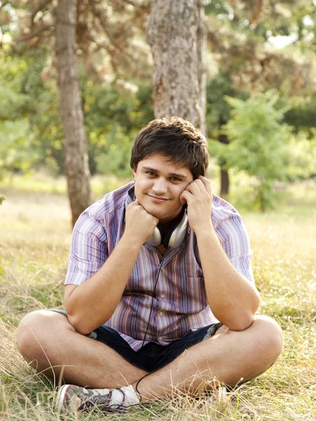 Smiling handsome man with headphones at outdoors — Stock Photo, Image