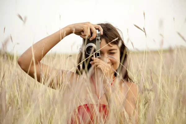 stock image Brunette girl with camera at outdoor.