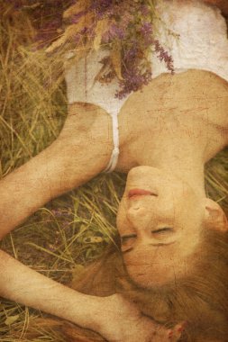 Beautiful girl lying down at grass. clipart
