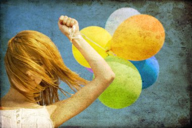 Redhead girl with colour balloons at blue sky background. clipart