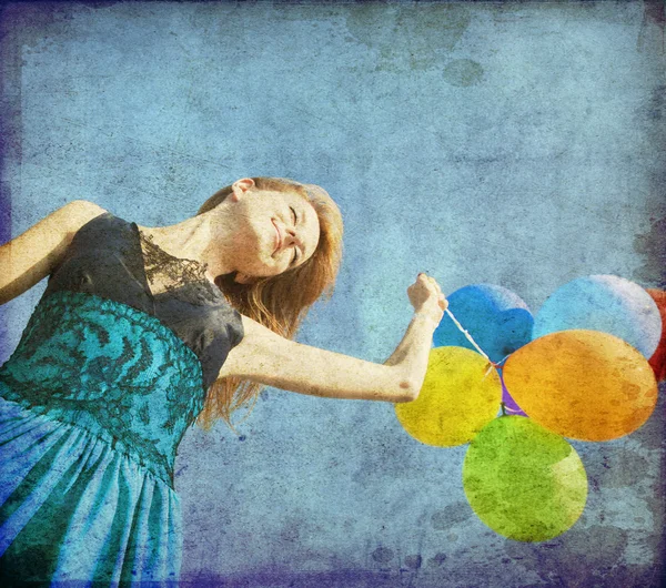 Redhead girl with colour balloons at blue sky background. — Stock Photo, Image