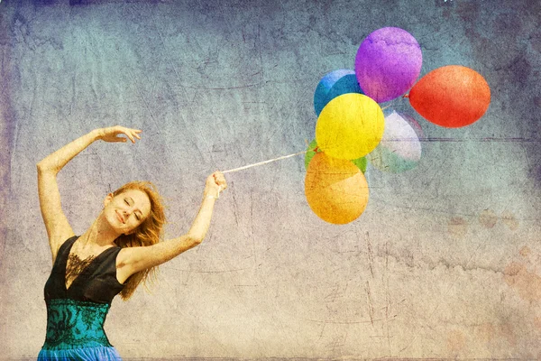 Redhead girl with colour balloons at blue sky background. — Stock Photo, Image
