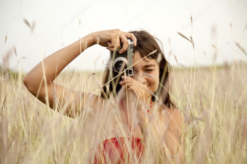 Brunette girl with camera at outdoor.