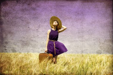 Lonely girl with suitcase at country. clipart