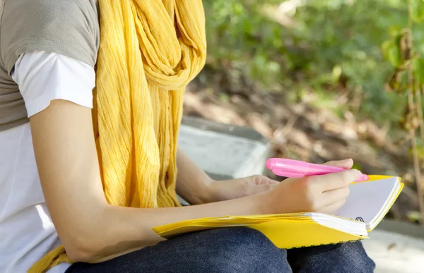 Schülerin händigt Notebook im Freien aus. — Stockfoto