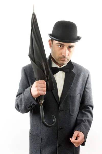Hombre con sombrero de jugador de bolos y un paraguas — Foto de Stock