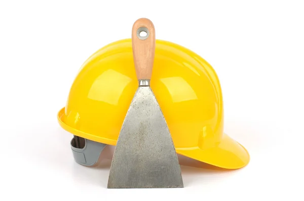 Yellow industrial safety helmet and stainless steel scraper — Stock Photo, Image