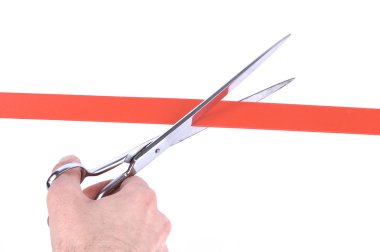 Man's hand cutting a red ribbon with scissors clipart