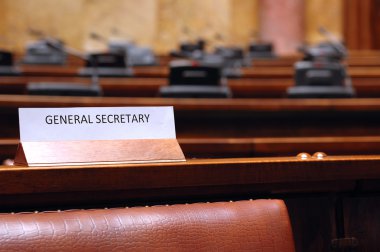 Empty General Secretary seat in conference hall clipart
