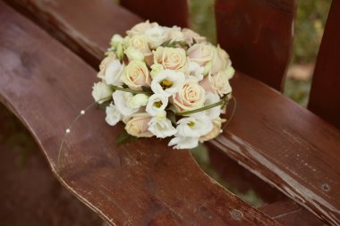 Bridal bouquet on the wooden bench