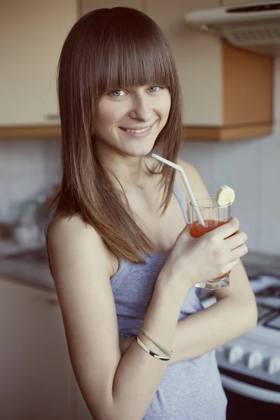 stock image Portrait of happy smiling woman drinking fresh orange juice in t