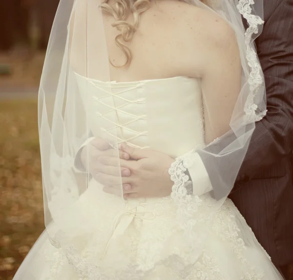 Groom embracing his bride — Stock Photo, Image