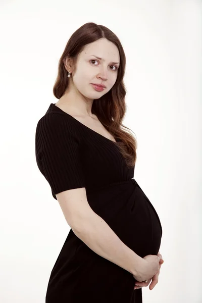 Bella donna incinta in un vestito nero — Foto Stock