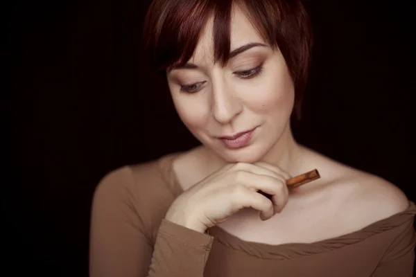 Girl with makeup and cinnamon in a hand — Stock Photo, Image