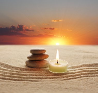 Stack of stones and candle light clipart