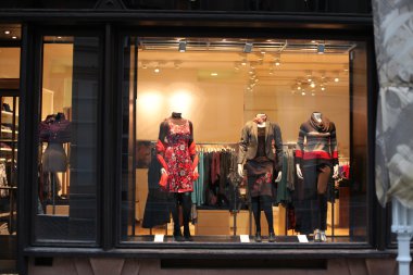 Boutique window with dressed mannequins clipart