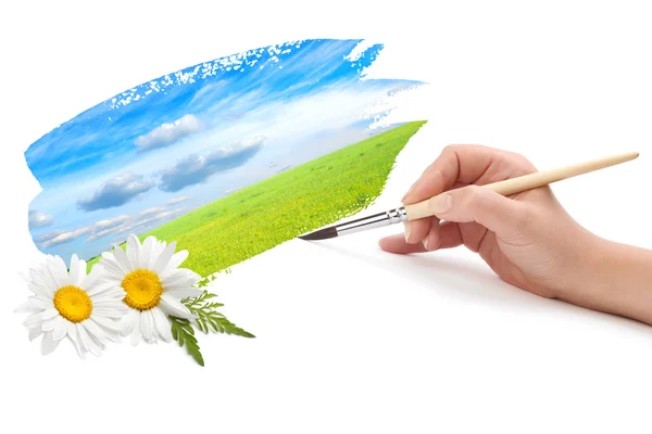 Hand with brush and landscape paint — Stock Photo, Image