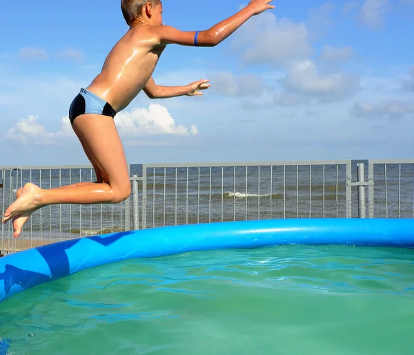 Boy jump in swimming pool — Stock Photo, Image