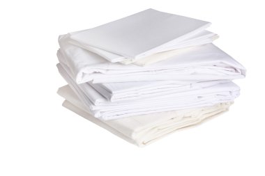 Pile of ironed white bed sheets