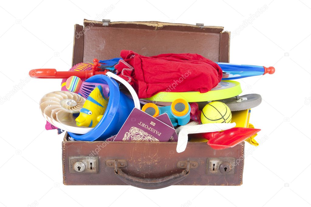 Open suitcase full of summer vacation or holiday things