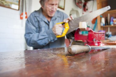 Chisel in the foreground of a workshop table, carpenter, carpent clipart