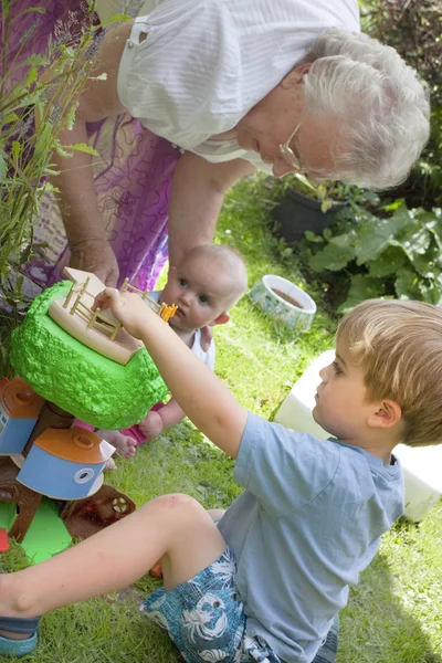 Grandma and children playing — Stok fotoğraf