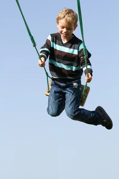 Happy child on a swing — Stock Photo, Image