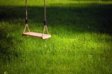 Swing in a garden clipart