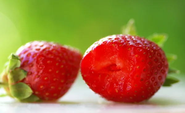 stock image Fresh strawberries in green background