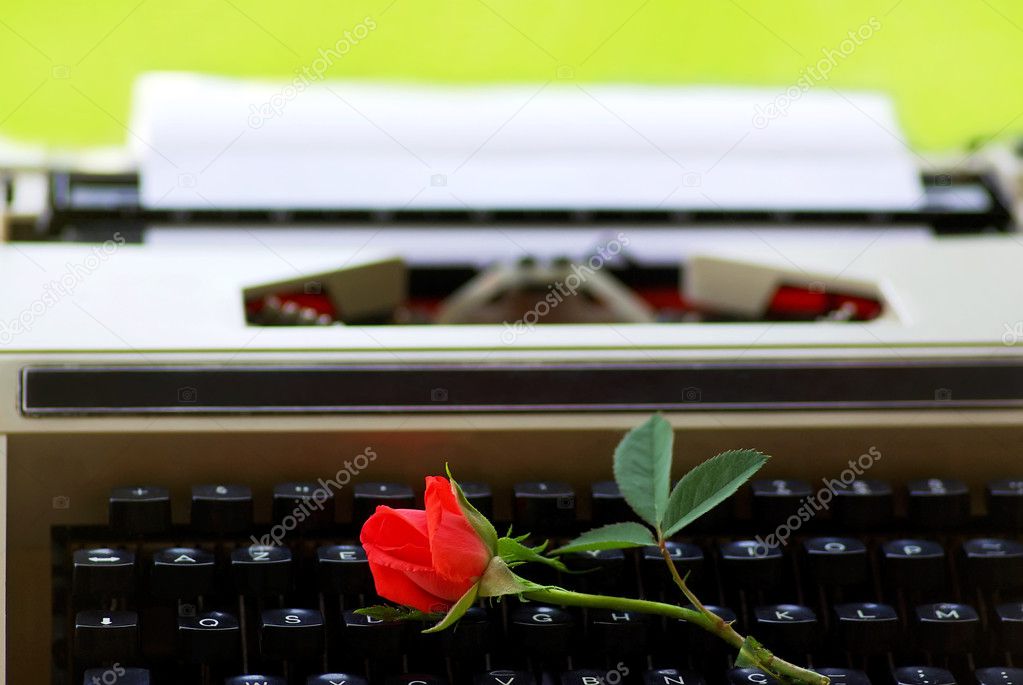 Red rose on keyboard of old Typing machine