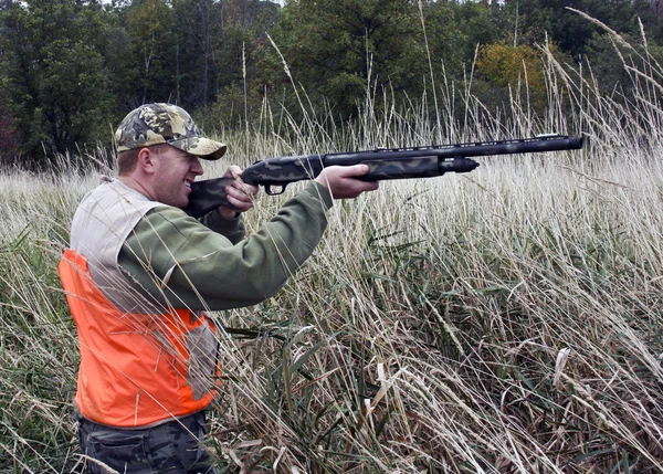 Hunter in marsh grass — Stock Photo, Image