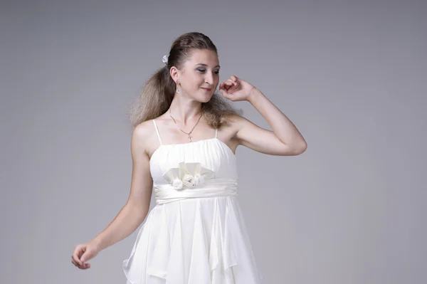Beautiful young woman in a white dress — Stock Photo, Image