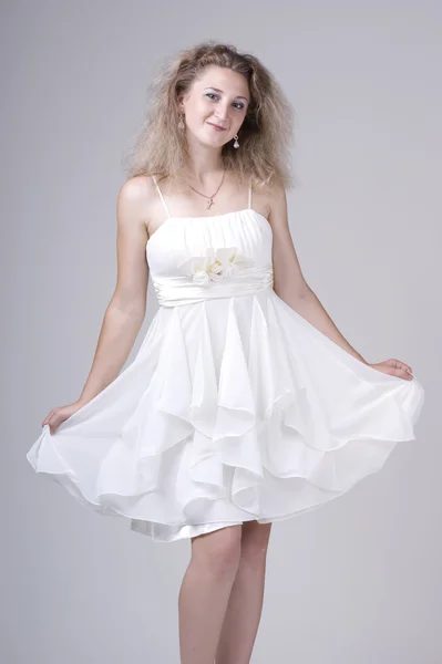 Beautiful young woman in a white dress — Stock Photo, Image