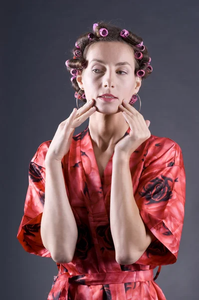 stock image Beautiful young woman with bigoudi on the hair